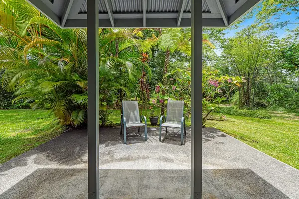Escape to a private tropical backyard oasis surrounded by lush Hawaiian landscaping, swaying palms, and the peaceful beauty of paradise.