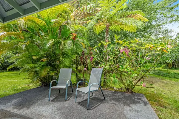 Escape to a private tropical backyard oasis surrounded by lush Hawaiian landscaping, swaying palms, and the peaceful beauty of paradise.