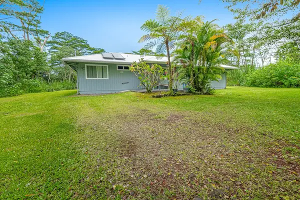 Escape to a private tropical backyard oasis surrounded by lush Hawaiian landscaping, swaying palms, and the peaceful beauty of paradise.