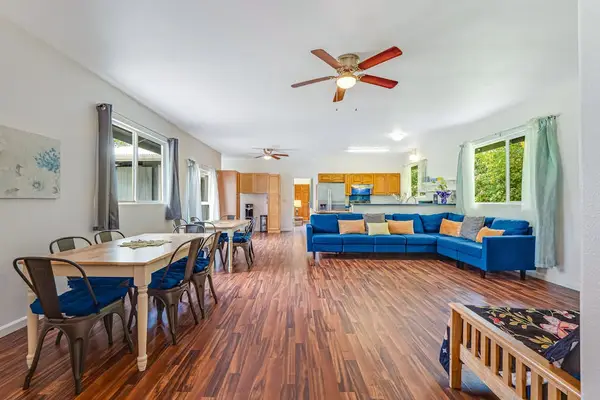 Large open living room with plenty of comfortable seating and a flat screen tv.