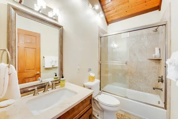 En-Suite Bathroom with Glass-Enclosed Shower & Wood Accents