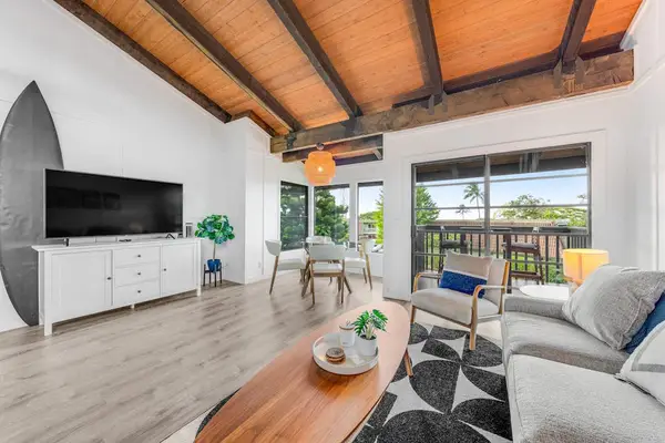 Coastal lounge offers television balcony access and soaring timber ceilings