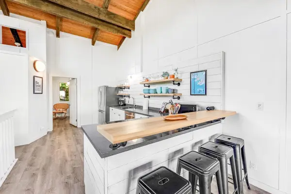 Bright kitchen island supplies stools prep space and modern appliances