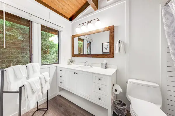 Full Bathroom shines with daylight double vanity and soaking tub