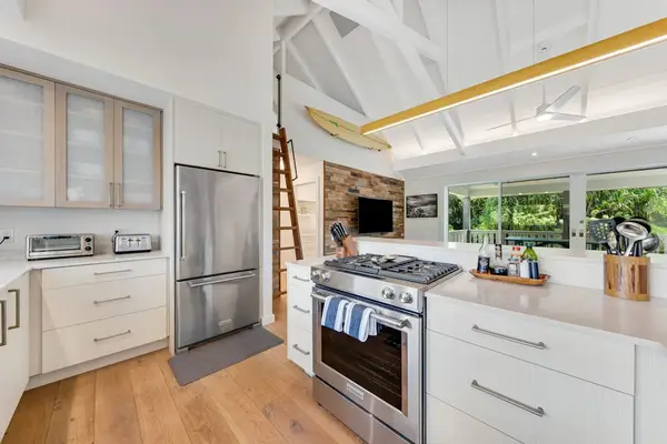 Modern kitchen combines practical appliances with preparation space and storage
