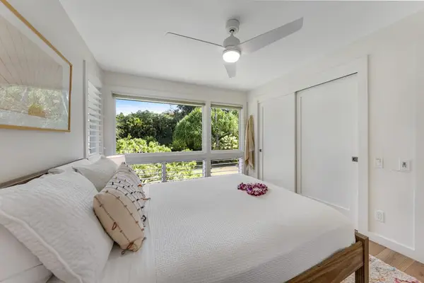 Well-designed bedroom features coordinated decor, comfortable bedding, and useful storage