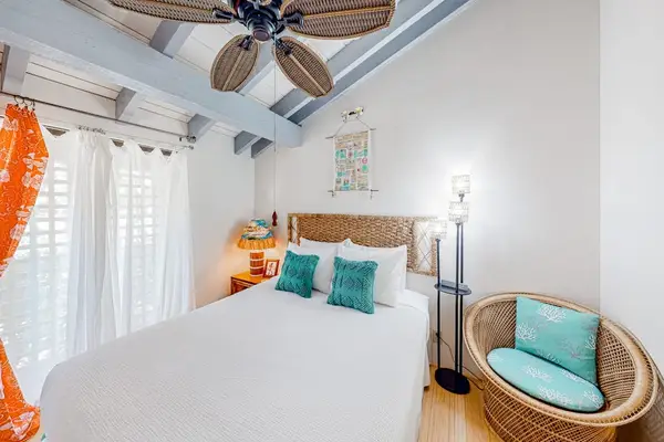 Second bedroom features comfortable seating chair for relaxing before restful nights together