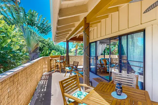 Patio provides seating beside greenery and open-air living spaces
