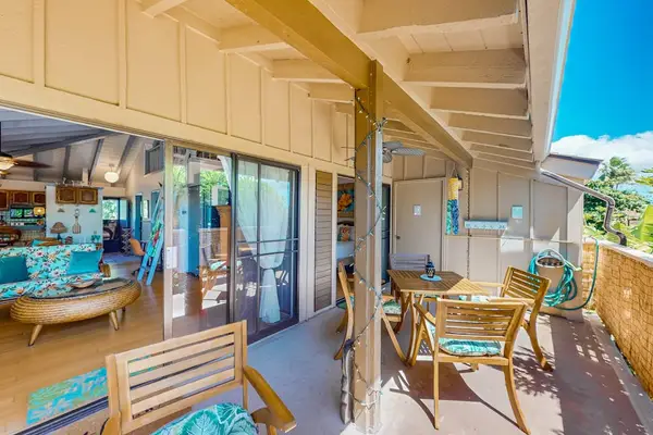 Covered patio extends space with dining table, seating, and views