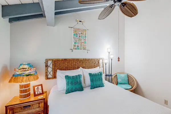Charming second bedroom features accent chair adding comfort and everyday convenience throughout