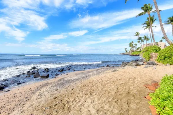 Crystal-clear turquoise waters gently wash onto pristine white sandy beaches.