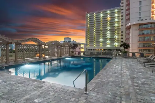 Unwind by the pool as the sun sets over the horizon