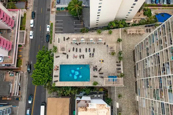 Aerial pool deck surrounded by resort amenities and island scenery