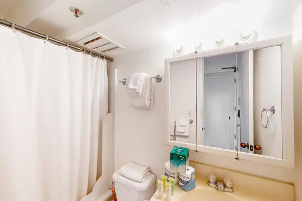 A spotless full bathroom designed for a relaxing stay