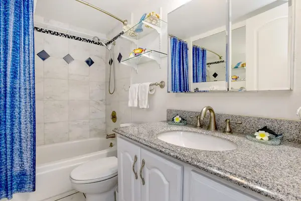 Bathroom with tub shower combo.