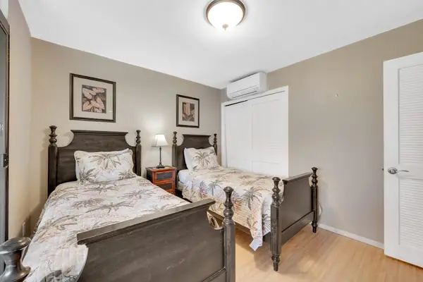 Spacious twin bedroom filled with natural light