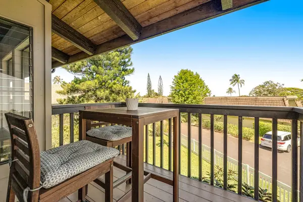 Wooden balcony table welcomes island breezes and peaceful tropical outlooks