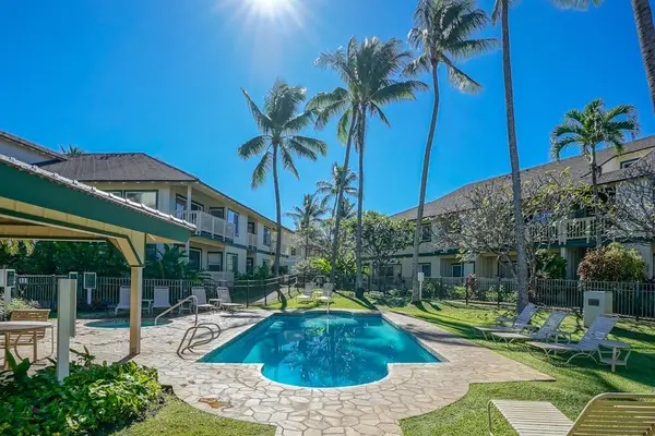 Relax by the resort-style pool surrounded by tropical palms