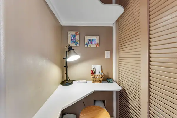 The bedroom features the perfect desk nook for setting up your laptop.