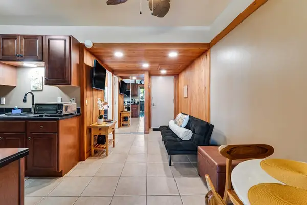 The interior is compact but thoughtfully designed, offering a sitting area with a TV, a bistro dining space, and a well-equipped kitchen with all-new stainless steel appliances and maple cabinetry.