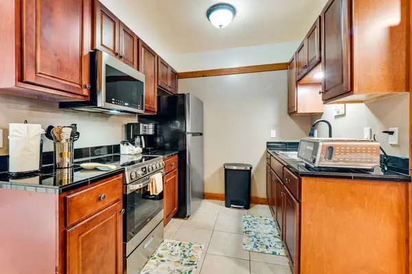 Well equipped kitchen with modern stainless steel appliances and new maple cabinetry.