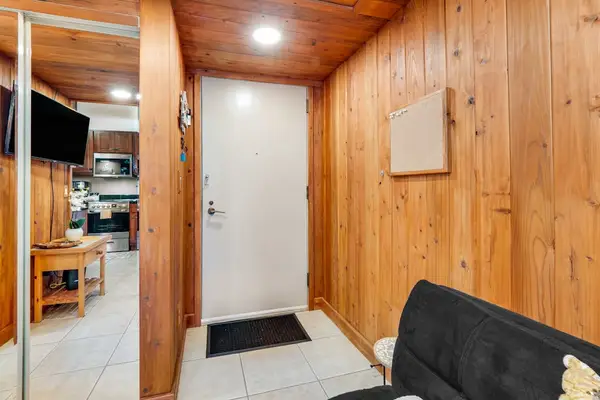 The interior is compact but thoughtfully designed, offering a sitting area with a TV, a bistro dining space, and a well-equipped kitchen with all-new stainless steel appliances and maple cabinetry.