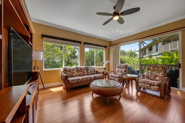 Bright living room with comfortable seating and tropical views
