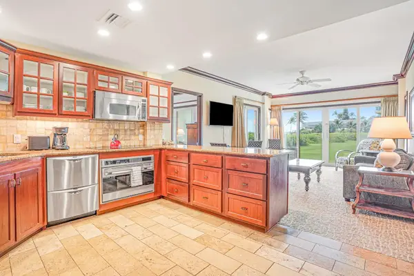 Modern stainless steel kitchen with an open-concept design that flows seamlessly into the living room, making it easy to cook, gather, and stay connected.