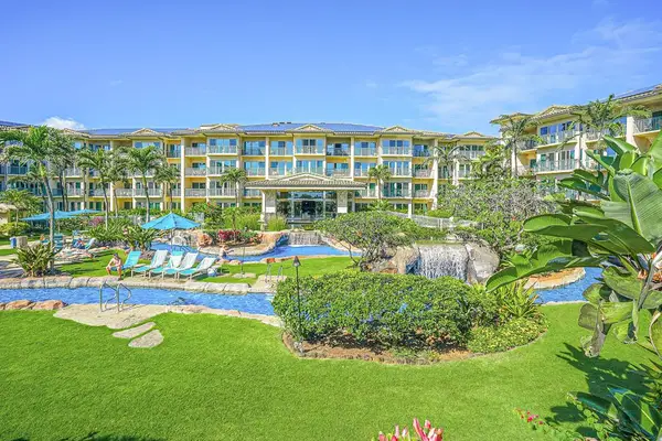 Waipouli Beach Resort is surrounded by lush tropical scenery, featuring a winding lazy river, cascading waterfalls, and a true island paradise atmosphere.