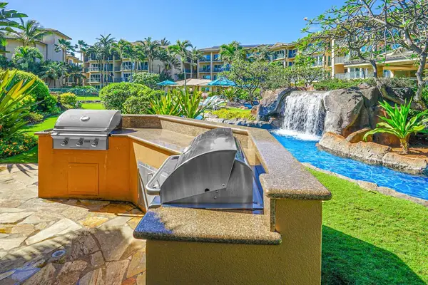 Enjoy the community grills overlooking the lazy river, where a cascading waterfall creates the perfect backdrop for outdoor dining and relaxing during your stay.