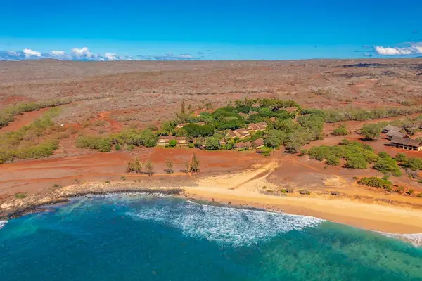 Nearby Pacific coastline stretches beyond the island landscape and turquoise water