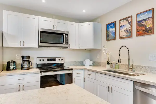 Spacious stainless steel kitchen with an open-concept design, allowing you to enjoy abundant natural light while staying connected with family and friends.
