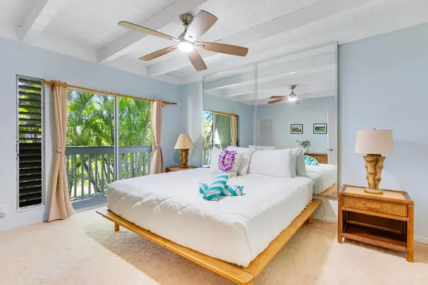 Master bedroom with ensuite bathroom, private lanai access, and en suite bathroom