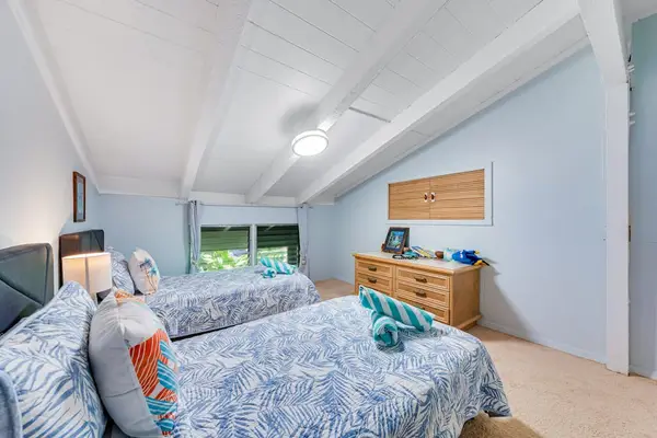 Guest room lofted ceilings and two twin beds.