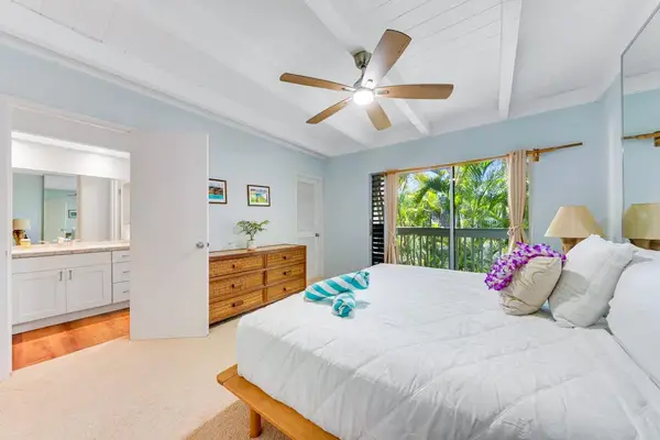 Master bedroom with king bed private lanai access and en suite bathroom.