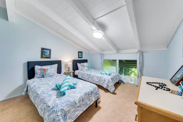 Guest room lofted ceilings and two twin beds.