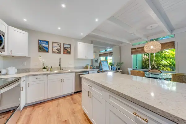 Modern open-concept kitchen featuring sleek stainless steel appliances, expansive countertops, and plenty of workspace for preparing everything from quick breakfasts to gourmet meals.