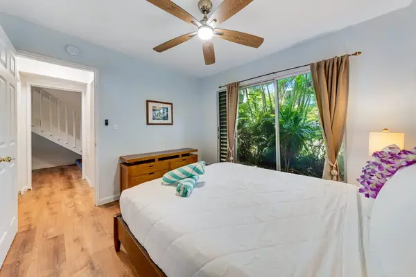 Guest room with queen bed sliding doors for easy lanai access and a ceiling fan for your comfort at night.