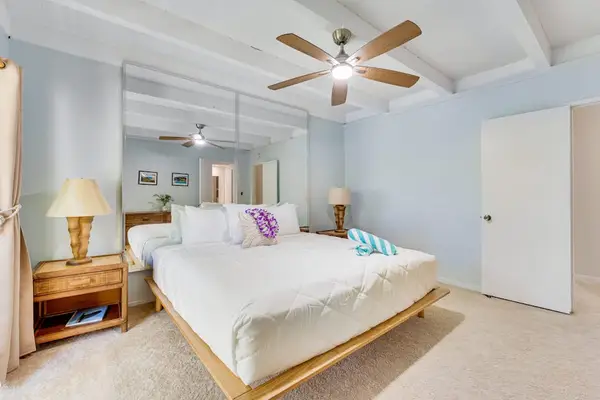 Master bedroom with king bed, private lanai access, en suite bathroom and a celling fan for ultimate comfort at night.
