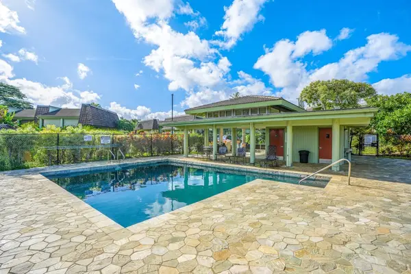Princeville Paradise at Puamana community pool with covered seating to relax in the shade.