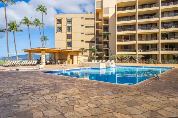 Sugar Beach Resort community pool beneath the swaying palm trees.