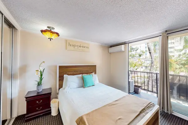 Wake up refreshed in a bright bedroom filled with natural light through the large glass windows.