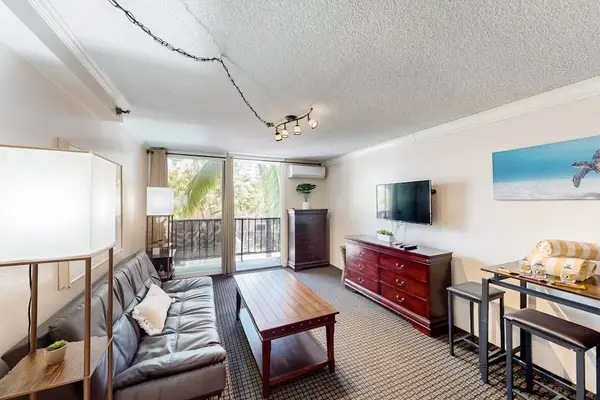 Relax, dine, and enjoy entertainment together in this comfortable living room with a dining area and TV.