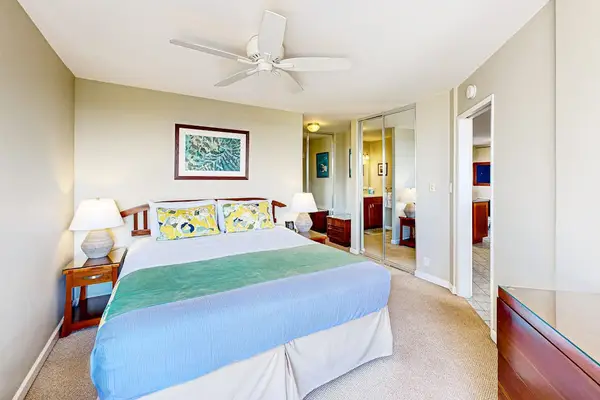 Spacious Primary Bedroom with Ceiling Fan & Mirrored Closet