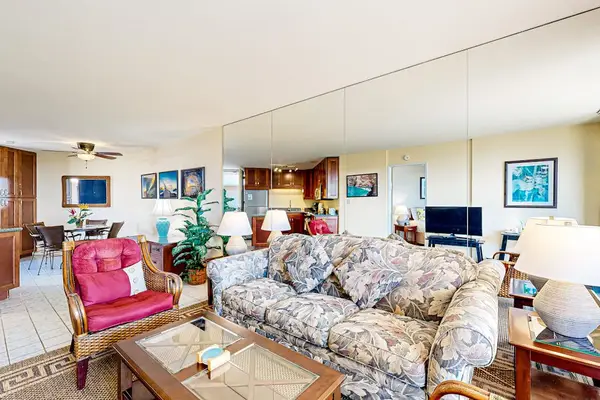 Spacious Living Area with Mirrored Wall & Tropical Decor