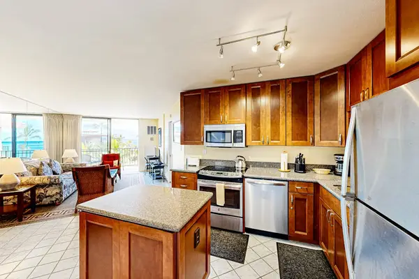 Open-Concept Kitchen & Island Overlooking Living Area