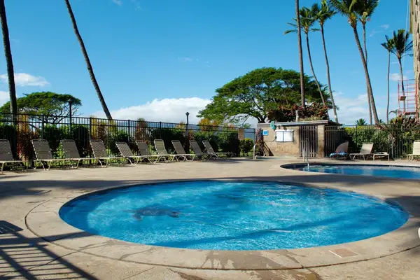 Resort Pool Deck with Lounge Chairs & Tropical Landscaping