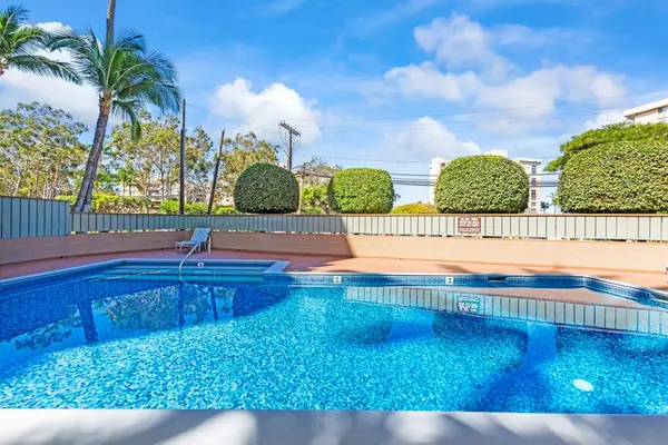 Sparkling Resort Pool Beneath Sunny Skies