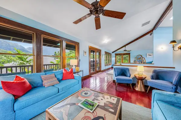 Bright living room showcases colorful seating, artwork, and panoramic windows