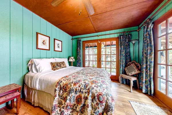 Master bedroom with king bed with and wall to ceiling feelings.